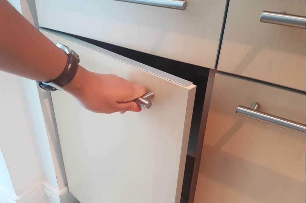 Hand opening cabinet in the kitchen